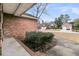 Close-up of a brick home's corner with a view of neighboring houses and manicured landscaping at 101 S Gateshead Crossing, Goose Creek, SC 29445