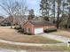 Aerial view of the home showcases brick exterior, a large garage, established landscaping, and circular driveway at 101 S Gateshead Crossing, Goose Creek, SC 29445