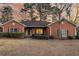 Charming brick home with manicured bushes and dark shutters set against a colorful sunset sky at 101 S Gateshead Crossing, Goose Creek, SC 29445