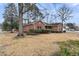 Traditional brick home with a manicured lawn and mature trees creating a serene setting at 101 S Gateshead Crossing, Goose Creek, SC 29445
