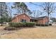 Quaint brick home with dark shutters and mature landscaping offering an inviting curb appeal at 101 S Gateshead Crossing, Goose Creek, SC 29445