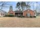 Traditional brick home with tidy landscaping, featuring a well-maintained lawn and mature trees at 101 S Gateshead Crossing, Goose Creek, SC 29445