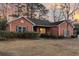 Well-maintained one-story red brick home with manicured landscaping and a warm inviting glow at 101 S Gateshead Crossing, Goose Creek, SC 29445