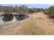 Picturesque golf course with a pond, cart path, and well-maintained greens, creating a serene and scenic landscape at 101 S Gateshead Crossing, Goose Creek, SC 29445