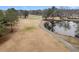 Picturesque golf course with a pond, cart path, and well-maintained greens, creating a serene and scenic landscape at 101 S Gateshead Crossing, Goose Creek, SC 29445