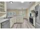 Bright kitchen featuring stainless steel appliances, granite countertops and seamless wood-look flooring that enhances the open-concept design at 101 S Gateshead Crossing, Goose Creek, SC 29445