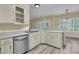 Kitchen featuring light countertops, stainless steel appliances, and abundant cabinetry with an open view to a sunny dining nook at 101 S Gateshead Crossing, Goose Creek, SC 29445