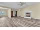 Spacious living room featuring a classic fireplace, with a large window for natural light and stylish wood-look flooring at 101 S Gateshead Crossing, Goose Creek, SC 29445