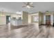 Open concept living area featuring modern flooring that flows seamlessly into a kitchen with breakfast bar and an adjacent dining space at 101 S Gateshead Crossing, Goose Creek, SC 29445