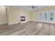 Bright living room with a cozy fireplace, updated floors, and French doors allowing ample sunlight at 101 S Gateshead Crossing, Goose Creek, SC 29445