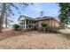 Back exterior view highlighting the screened porch and the home's classic brick construction amidst a lush landscape at 101 S Gateshead Crossing, Goose Creek, SC 29445
