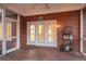 Cozy screened-in porch with rustic charm, featuring a brick accent wall and charming decor at 101 S Gateshead Crossing, Goose Creek, SC 29445