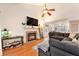 Bright living room features a fireplace, hardwood floors, and a ceiling fan at 102 Shoveler Pl, Summerville, SC 29485