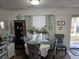 Cozy dining area with a decorative table setting, shelving, and window with curtains at 110 Greyson Cir, Goose Creek, SC 29445