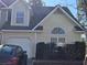 Charming two-story home with attached garage, manicured bushes, and appealing architectural details at 110 Greyson Cir, Goose Creek, SC 29445
