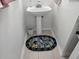 This compact powder room features a pedestal sink and charming rug, maximizing space and adding character at 110 Greyson Cir, Goose Creek, SC 29445