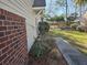 This is the side yard, featuring a brick foundation, vinyl siding, and a sidewalk at 110 Greyson Cir, Goose Creek, SC 29445