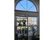 Lots of light streams in through this large window highlighting a collection of plants and decor at 110 Greyson Cir, Goose Creek, SC 29445