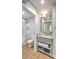 Bathroom featuring a vanity with marble countertop, modern fixtures, and storage for towels at 1126 Ocean Blvd # 109116230, Isle of Palms, SC 29451