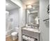 Bathroom featuring a vanity with marble countertop, modern mirror and cabinet storage at 1126 Ocean Blvd # 109116230, Isle of Palms, SC 29451