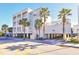 Exterior view of multi-story beach hotel with palm trees, covered parking and hotel entrance at 1126 Ocean Blvd # 109116230, Isle of Palms, SC 29451