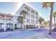 Exterior day view of multi-story beach hotel with balconies and palm trees along the street at 1126 Ocean Blvd # 109116230, Isle of Palms, SC 29451