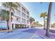 Multi-story beach hotel with balconies and palm trees along the street on a sunny day at 1126 Ocean Blvd # 109116230, Isle of Palms, SC 29451