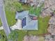 Aerial view of a house with a solar panel roof, lush landscaping, and outdoor seating on a deck at 1228 Brookside Dr, Hanahan, SC 29410
