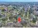 Aerial view of the neighborhood with trees, nearby school, and the home is marked with an arrow at 1228 Brookside Dr, Hanahan, SC 29410