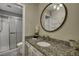 Bathroom with granite countertop, decorative mirror, and a glass-enclosed shower at 1228 Brookside Dr, Hanahan, SC 29410