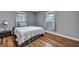 Neutral bedroom featuring hardwood floors, bright natural light, and a comfy bed at 1228 Brookside Dr, Hanahan, SC 29410