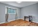 Bright bedroom with hardwood floors, neutral walls, and a minimalist desk at 1228 Brookside Dr, Hanahan, SC 29410