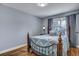 Cozy bedroom with wood floors, an ornate metal bed frame, and soft natural light at 1228 Brookside Dr, Hanahan, SC 29410