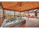 Backyard hot tub with a wooden deck, a screened-in patio, and outdoor seating at 1228 Brookside Dr, Hanahan, SC 29410