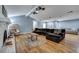 Bright living room features hardwood floors, a brick fireplace, a comfortable sectional, and natural light at 1228 Brookside Dr, Hanahan, SC 29410