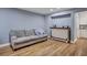 Cozy living room with neutral sofa, hardwood floors, bar area, and a doorway to the kitchen at 1228 Brookside Dr, Hanahan, SC 29410