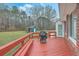 Spacious backyard featuring a red painted wooden deck and a charming storage shed at 131 Londonderry Rd, Goose Creek, SC 29445