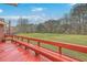 Expansive backyard view from the red painted wooden deck, perfect for outdoor gatherings at 131 Londonderry Rd, Goose Creek, SC 29445