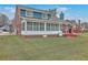 This home features a screened porch and deck that overlooks a large backyard with mature lawn at 131 Londonderry Rd, Goose Creek, SC 29445
