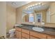 Well-lit bathroom featuring a spacious vanity, granite countertop, and a large mirror at 131 Londonderry Rd, Goose Creek, SC 29445