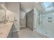 Modern bathroom with dual sinks, large walk-in shower, and a spacious layout with natural light from a skylight at 131 Londonderry Rd, Goose Creek, SC 29445