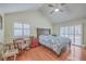 A cozy bedroom with hardwood floors, vaulted ceiling, a ceiling fan and large windows for natural light at 131 Londonderry Rd, Goose Creek, SC 29445