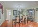 Dining room with glass table, display cabinets, and hardwood flooring at 131 Londonderry Rd, Goose Creek, SC 29445