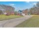 Side view of a two-story brick home, featuring a long driveway and manicured lawn at 131 Londonderry Rd, Goose Creek, SC 29445