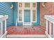 Close-up of a blue front door with painted wood porch, adding a touch of charm at 131 Londonderry Rd, Goose Creek, SC 29445