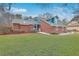 Attractive brick home featuring a manicured lawn and colorful landscaping at 131 Londonderry Rd, Goose Creek, SC 29445