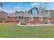 Inviting brick home with a well-maintained lawn and a quaint, blue-accented entrance at 131 Londonderry Rd, Goose Creek, SC 29445