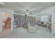 A bright and spacious living room featuring a ceiling fan, a comfortable sofa, and built-in shelves at 131 Londonderry Rd, Goose Creek, SC 29445