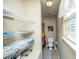 Functional bathroom with shelving for towels, a toilet, and a shower with a decorative curtain and ample light at 1320 Garland St, North Charleston, SC 29420
