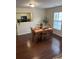 Bright dining area featuring hardwood floors, a window, and a view into the kitchen at 1320 Garland St, North Charleston, SC 29420